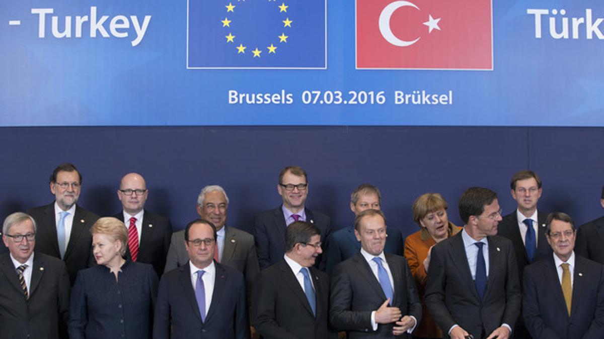 Turkish Prime Minister Ahmet Davutoglu poses with European Union leaders during a EU-Turkey summit in Brussels
