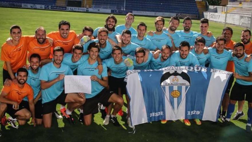 La plantilla y el cuerpo técnico posa en El Collao con la bandera del Alcoyano y un mensaje de ánimo para el lesionado Tomás Ruso.