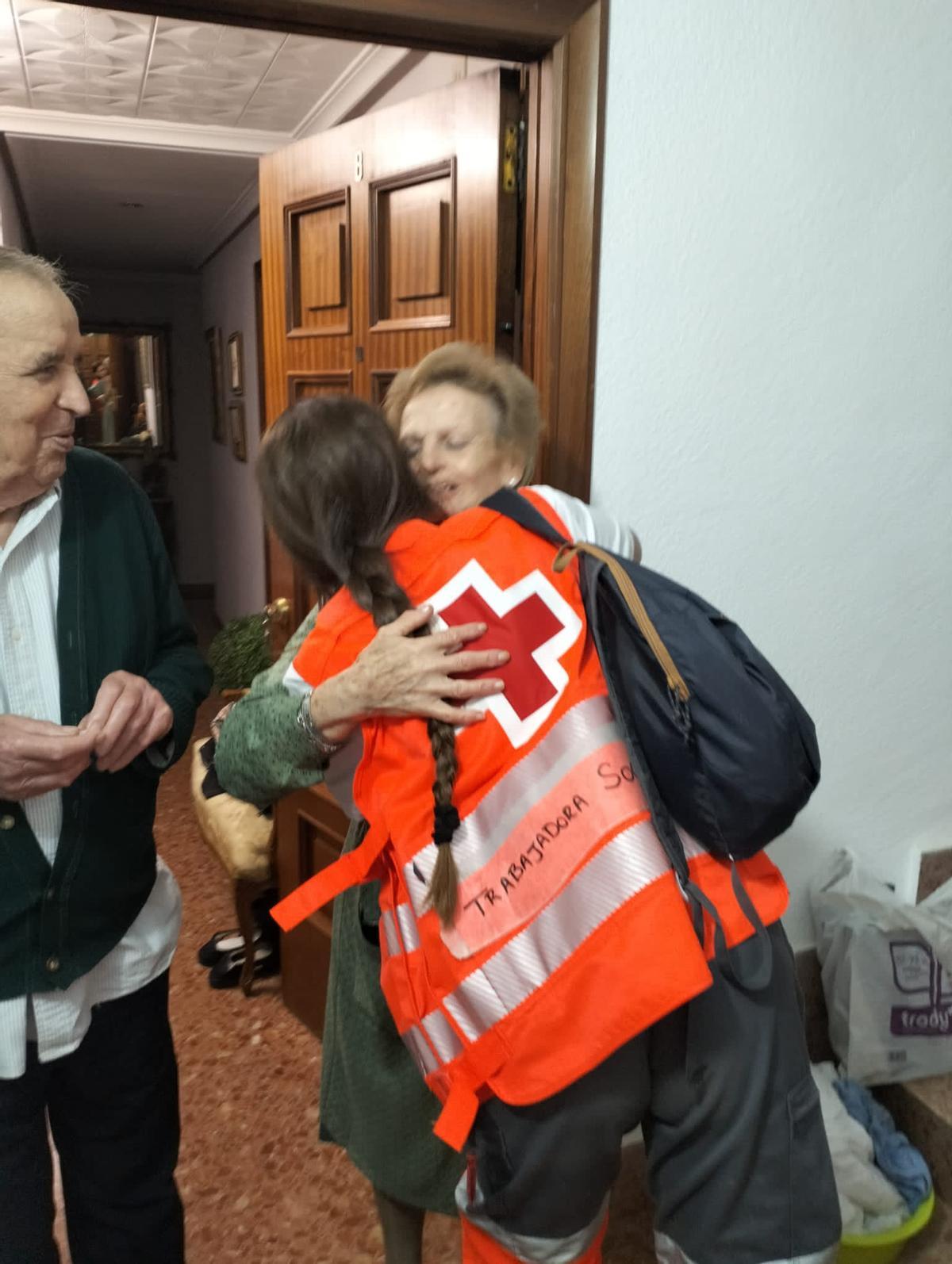 Trabajadores sociales de Cruz Roja atienden a las personas mayores.