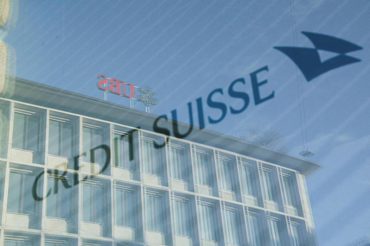 Logos of Swiss banks UBS and Credit Suisse are seen in Zurich