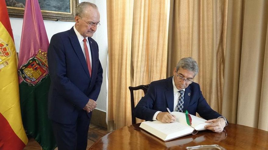 El delegado del Gobierno en Andalucía firma en el libro de honor del Ayuntamiento.