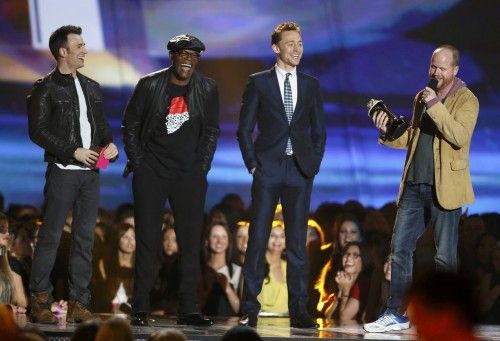Joss Whedon accepts the award for movie of the year with Chris Evans, Samuel L. Jackson and Tom Hiddleston at the 2013 MTV Movie Awards in Culver City, California