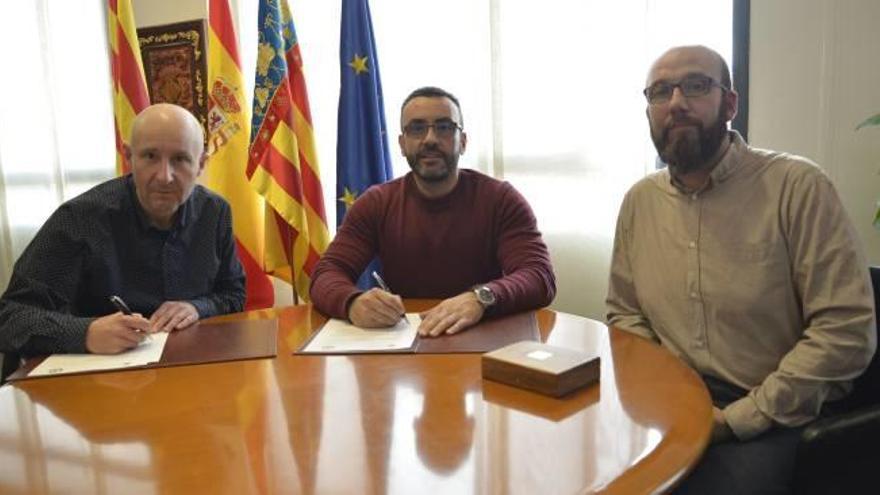 Firma del convenio entre Benlloch y Usó, acompañados por Cortells.