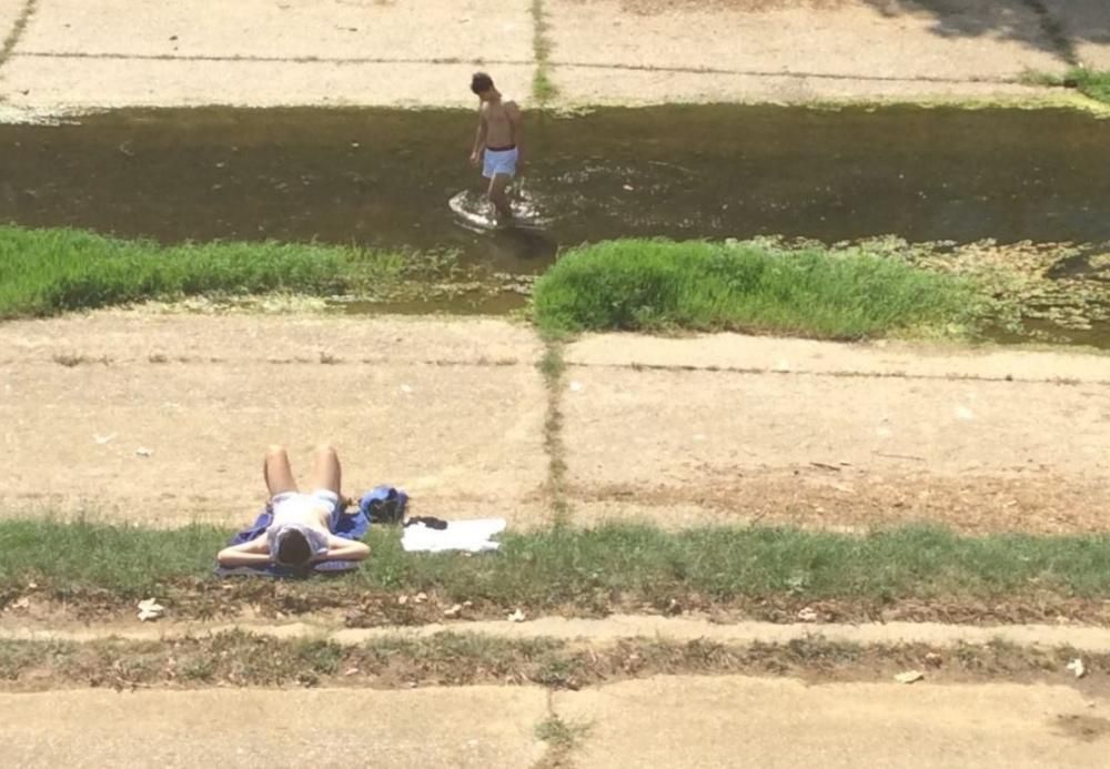 Dos joves s''han refrescat aquest dimecres a les aigües de l''Onyar al centre de Girona