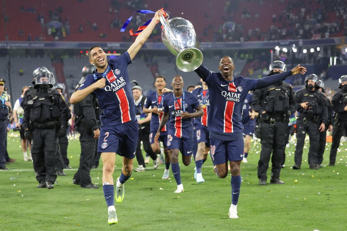 Munich (Germany), 31/05/2025.- Ousmane Dembele (R) and Achraf Hakimi (L) of PSG celebrate with the trophy after winning the UEFA Champions League final between Paris Saint-Germain and Internazionale Milano, in Munich, Germany 31 May 2025. (Liga de Campeones, Alemania) EFE/EPA/CHRISTOPHER NEUNDORF. paris saint germain psg . inter. liga campeones 2024/2025 paris saint germain psg . inter. final. accion. allianz arena