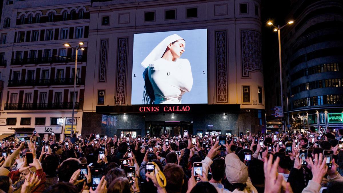 20/10/2025 Decenas de personas observan la portada del nuevo álbum de Rosalía, 'Lux', en la plaza de Callao.