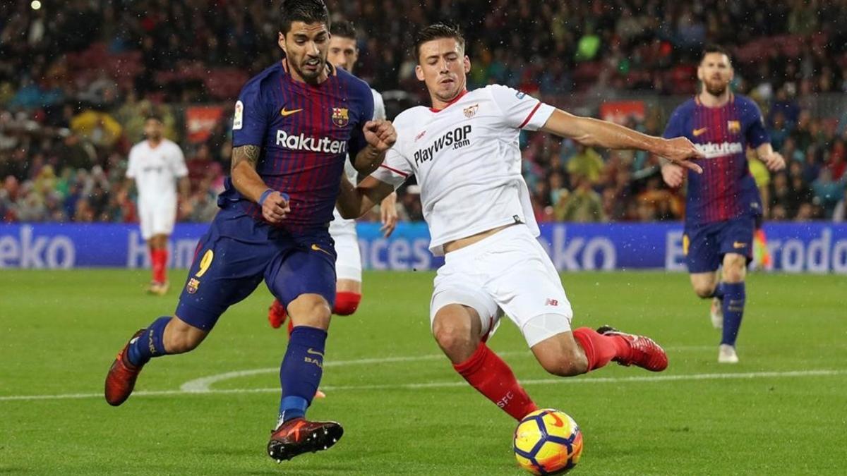 Luis Suárez pugna por un balón ante Clement Lenglet.