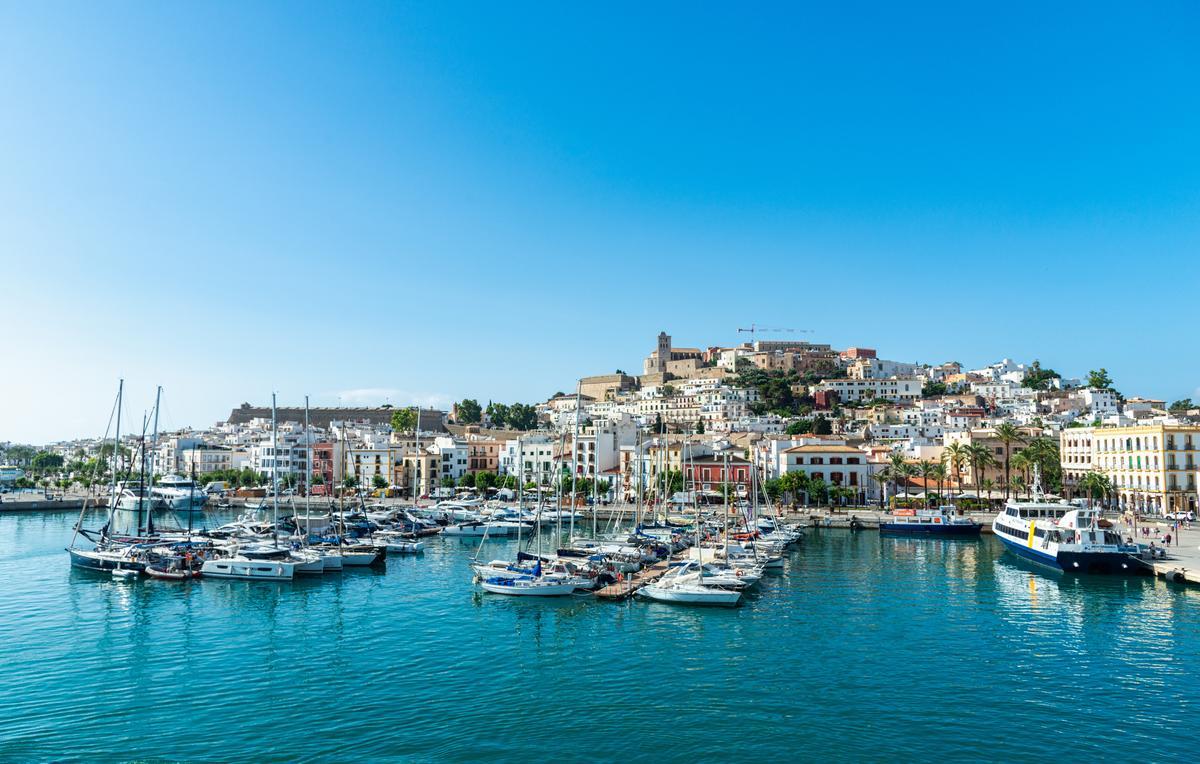 Shot of Ibiza's harbor with boats and Dalt Vila at the top.