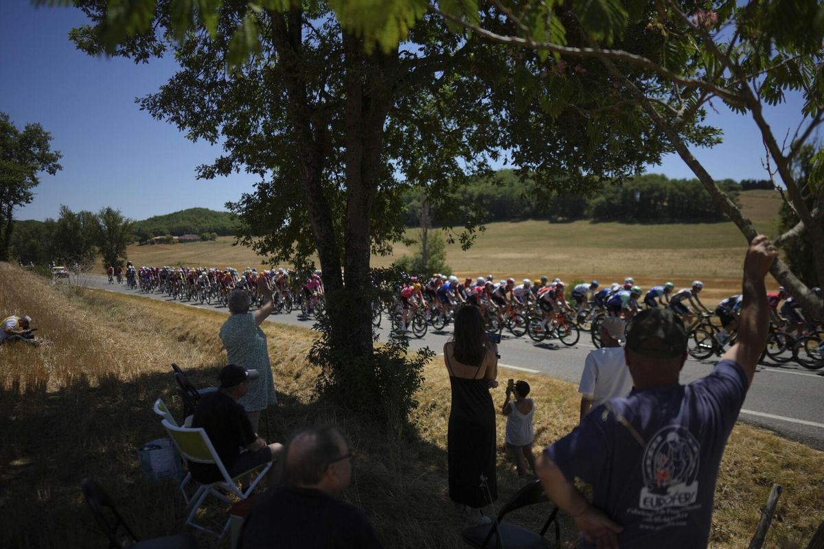 Spectators watch the pack during the twelfth stage of the Tour de France cycling race over 180.6 kilometers (112.2 miles) with start in Auch and finish in Hautacam, France, Thursday, July 17, 2025. (AP Photo/Thibault Camus)
