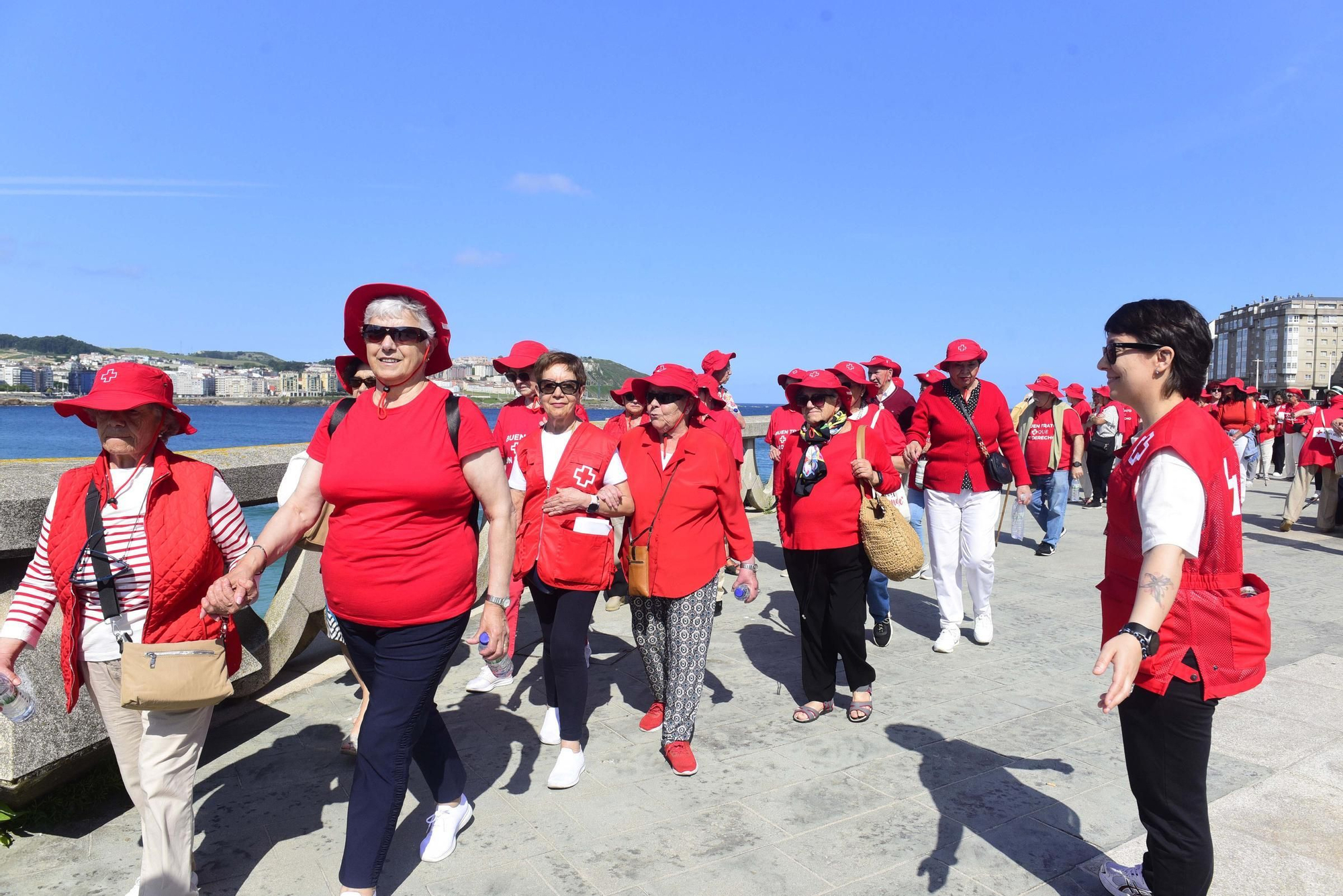 Voluntarios de Cruz Roja acompañan a mayores en un paseo por el Día contra el abuso y maltrato en la vejez