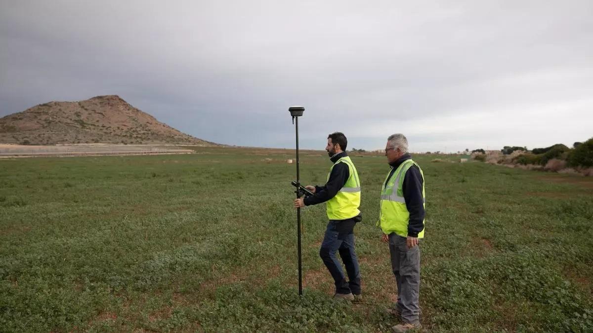 Los técnicos toman medidas para calcular la topografía del terreno antes de que comiencen los trabajos del cinturón verde.