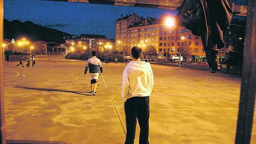 Jóvenes jugando al fútbol, ayer por la tarde, en la pista del barrio de La Tenderina.