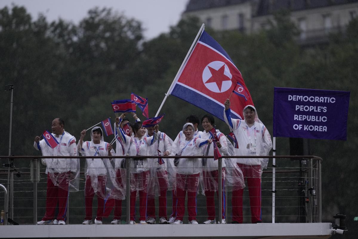 Democratic Republic of Korea team parades along the Seine river in Paris, France, during the opening ceremony of the 2024 Summer Olympics, Friday, July 26, 2024.. (AP Photo/Luca Bruno)