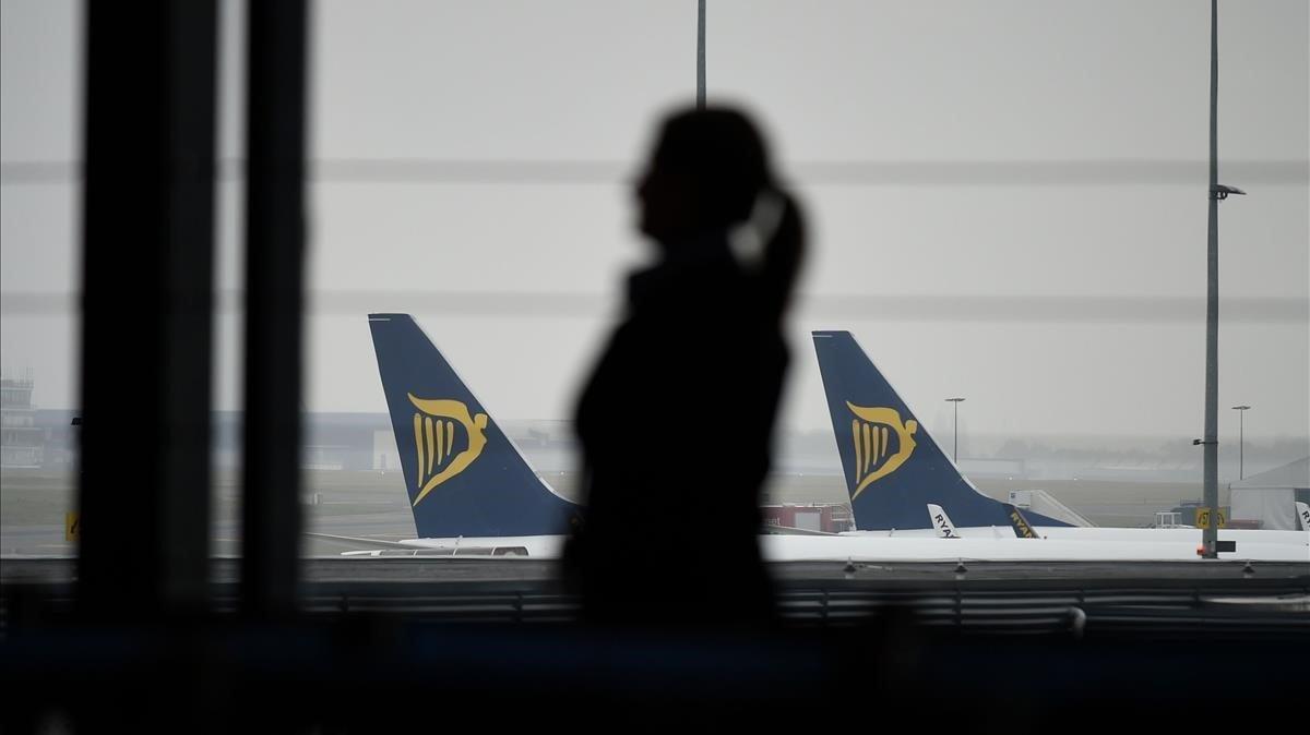 zentauroepp45237429 a groundstaff stands in a terminal with ryanair planes in ba190325210212