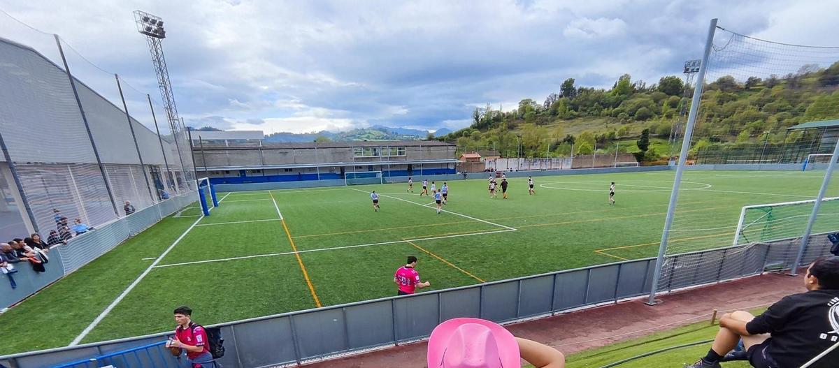 Campo de fútbol de césped artificial de Grado, en El Casal, con una de las torres de iluminación a la izquierda de la imagen, al fondo.