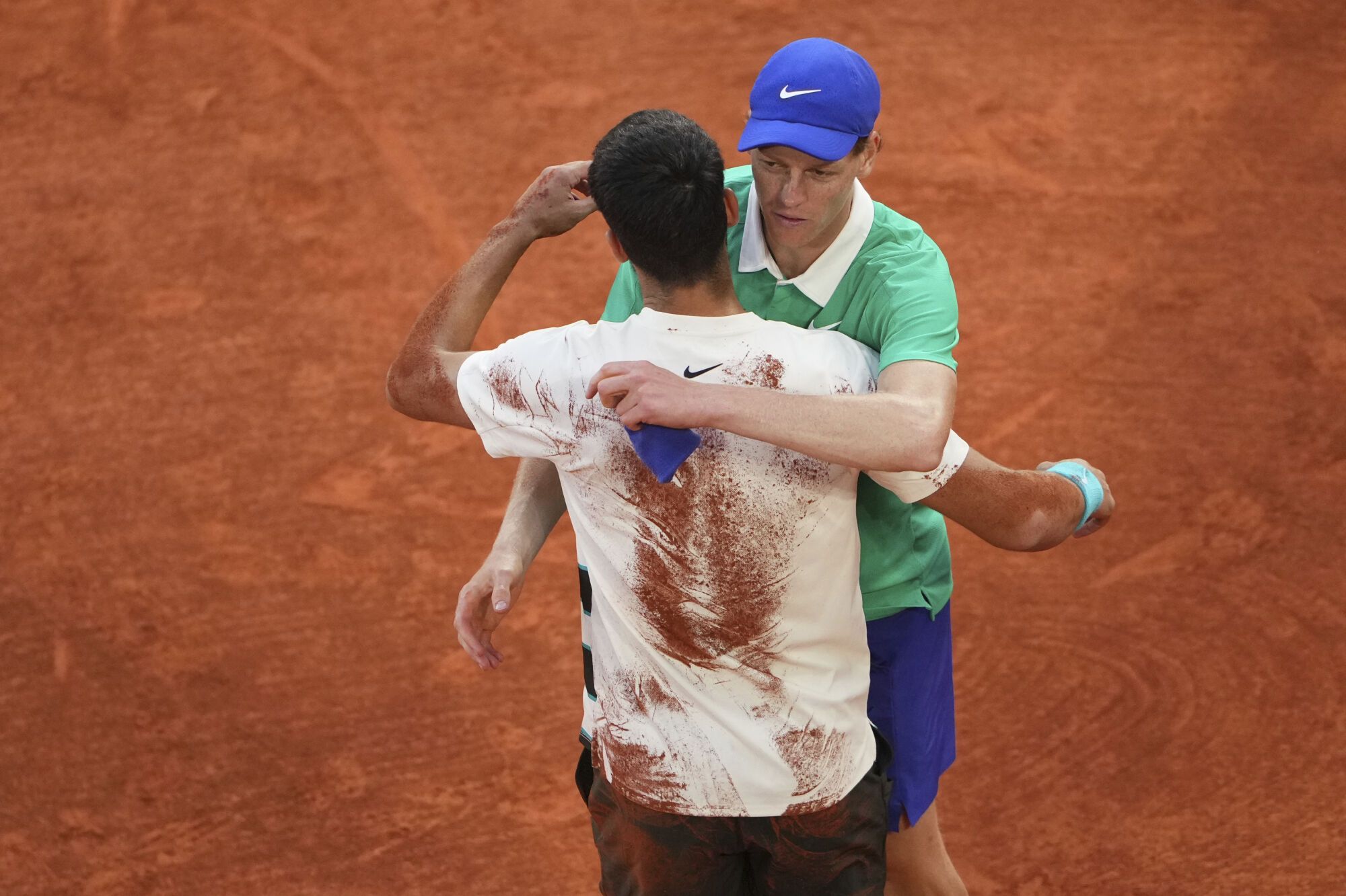 Winner Spain's Carlos Alcaraz, left, and Italy's Jannik Sinner hug after their final match of the French Tennis Open at the Roland-Garros stadium in Paris, Sunday, June 8, 2025. (AP Photo/Lindsey Wasson)