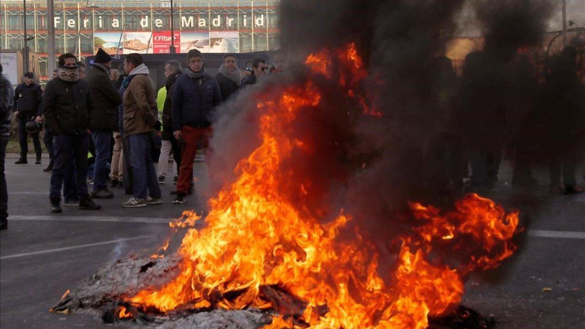 Los taxistas de Madrid queman neumáticos a las puertas de Ifema