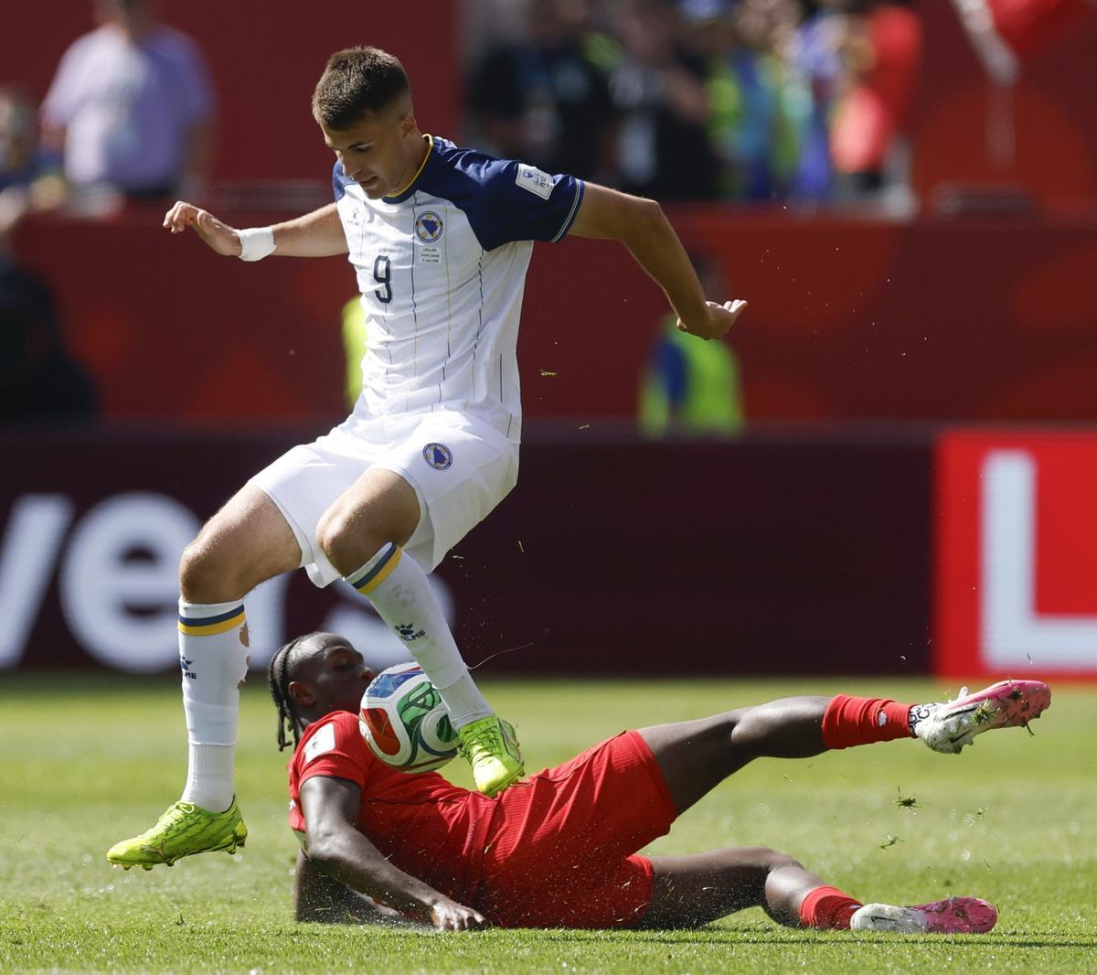 Bazdar se intenta llevar un balón ante un jugador de Canadá.
