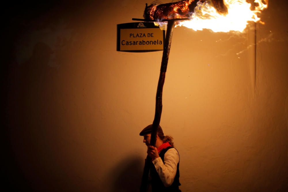 A villager holds a torch to represent light and ...