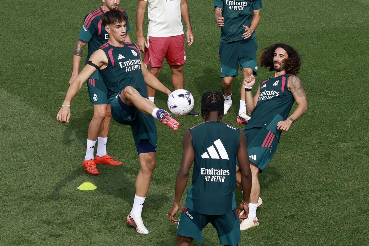 El defensa del Real Madrid Marc Cucurella (d) y el delantero Carlos Espí (i) durante el entrenamiento del equipo previo al primer partido oficial de la temporada para el equipo blanco, contra el Espanyol, correspondiente a la segunda jornada de LaLiga.