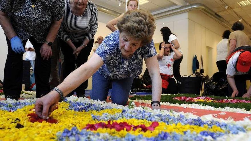 Participantes en la actividad, ayer, colocando las flores. // Bernabé/Javier Lalín