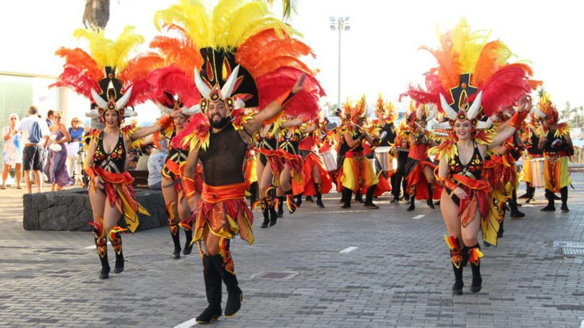 Las comparsas Los Cumbancheros y Los Timanfeiros durante el pasacalle inaugural del Yaiza Simply Love en Playa Blanca. | | AYUNTAMIENTO DE YAIZA