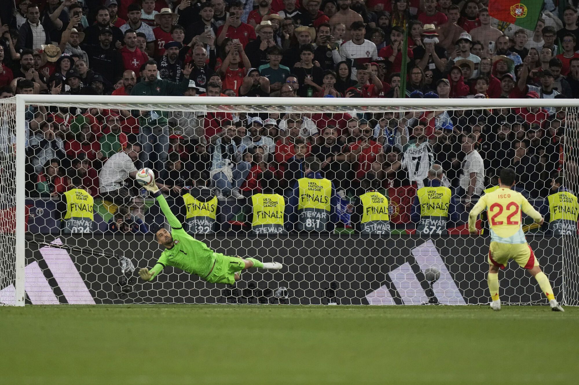 Spain's Isco, right, shoots to score past Portugal goalkeeper Diogo Costa during penalty shootout of the Nations League final soccer match between Portugal and Spain at the Allianz Arena in Munich, Germany, Sunday, June 8, 2025. (AP Photo/Matthias Schrader)
