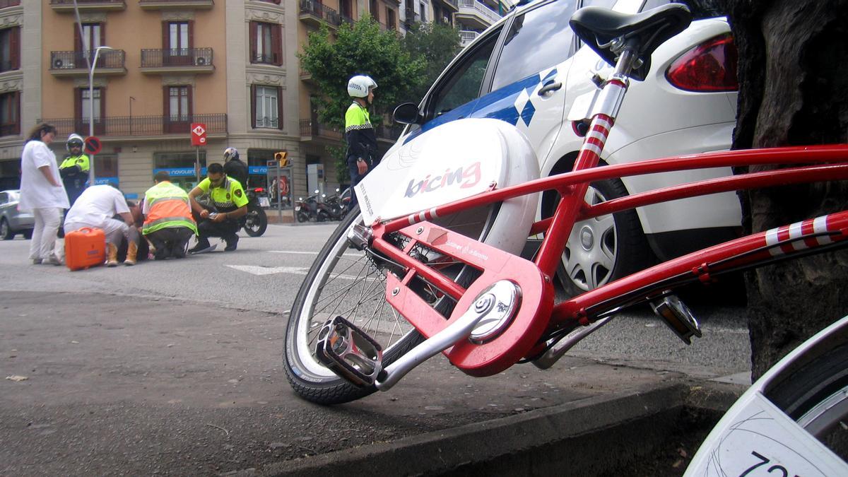 Sanitarios atienden a un ciclista herido en un siniestro en las calles de Barcelona