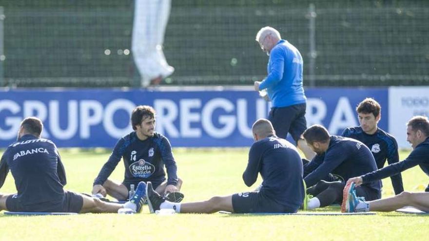 Varios de los que fueron titulares en el Camp Nou y Arribas, que entró por Sidnei a la media hora, realizan estiramientos ayer sobre el césped de Abegondo.