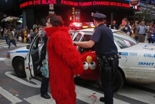A man, dressed as the Muppet character Elmo, is arrested in New York's Times Square