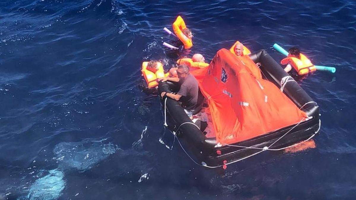 Los tripulantes de la lancha incendiada, en la balsa de emergencia y con chalecos salvavidas esperando a ser rescatados.
