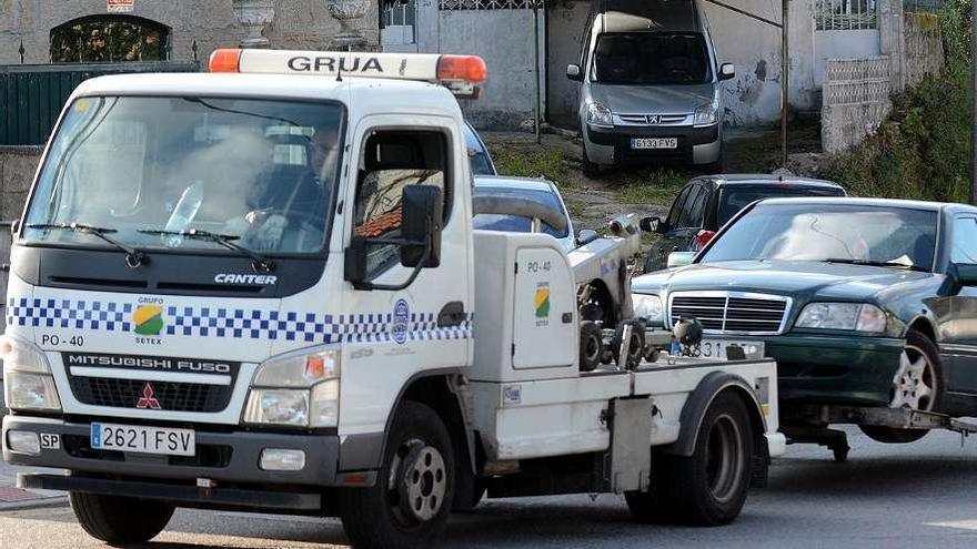 La grúa municipal retira un vehículo mal estacionado y lo lleva al depósito.  // Rafa Vázquez