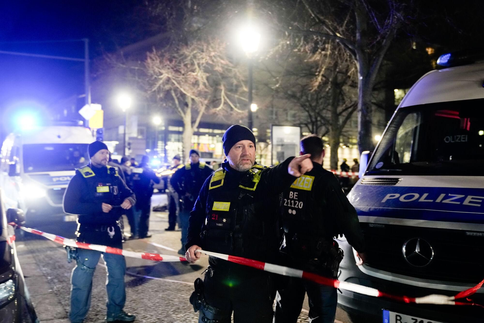 Police officers attend the scene at the Holocaust memorial after a man was attacked at the memorial site in Berlin, Germany, Friday, Feb. 21, 2025. (AP Photo/Ebrahim Noroozi)