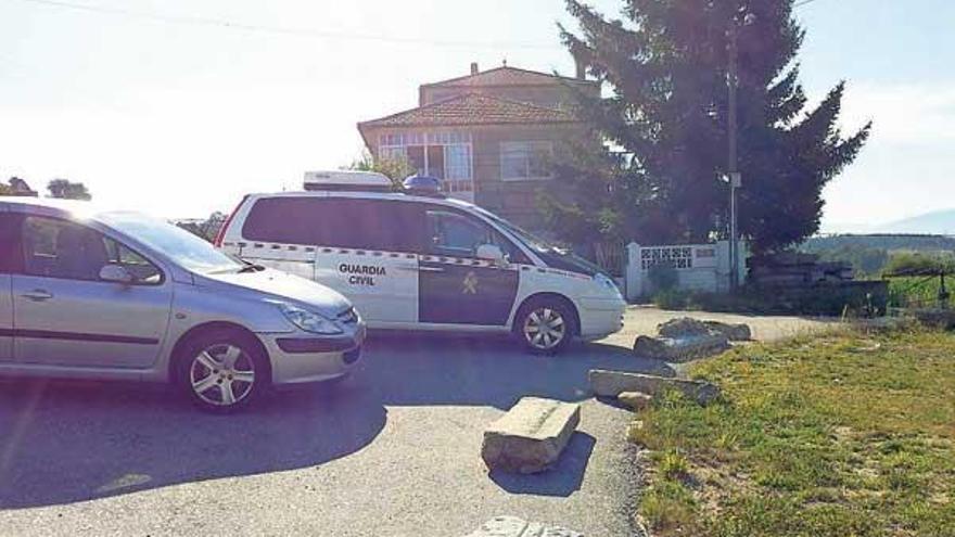 Un vehículo de la Guardia Civil, ayer, ante la vivienda del matrimonio herido en A Cañiza.  // G.P.