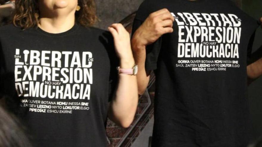 Dos personas muestran sus camisetas reivindicativas en acto de apoyo a los procesados. // La Insurgencia