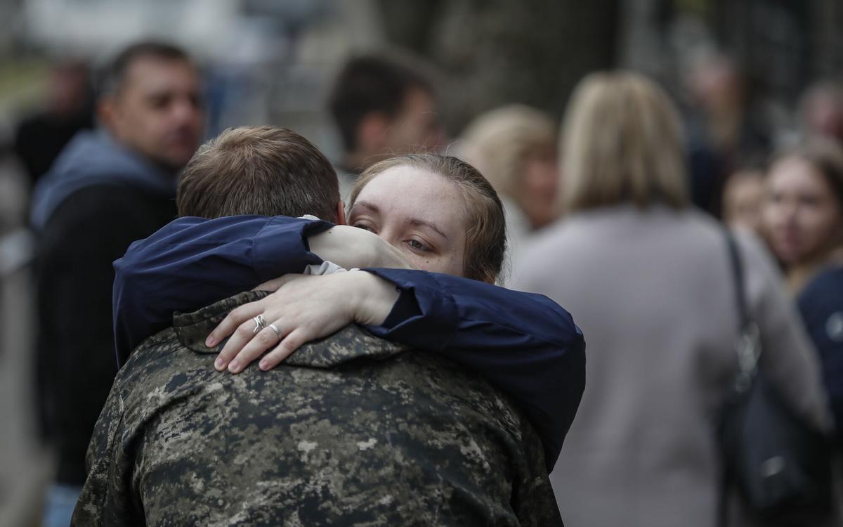 Un hombre ruso reclutado se despide de sus familiares en una oficina de reclutamiento durante la movilización militar parcial de Rusia en Moscú, en 2022.