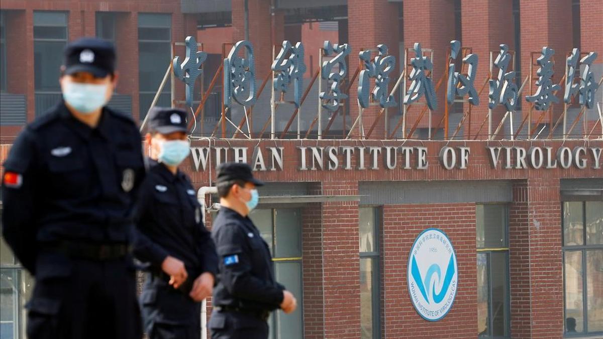 Security personnel keep watch outside the Wuhan Institute of Virology during the visit by the World Health Organization (WHO) team tasked with investigating the origins of the coronavirus disease (COVID-19)  inA Wuhan  Hubei province  China February 3  2021  REUTERS Thomas Peter