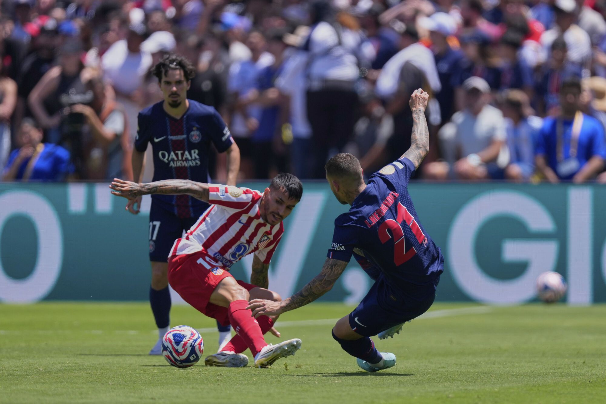 Atletico Madrid's Angel Correa, left, fights for the ball with Paris Saint-Germain's Lucas Hernandez during the Club World Cup group B soccer match between PSG and Atletico Madrid, in Pasadena, Calif., Sunday, June 15, 2025. (AP Photo/Mark J. Terrill)