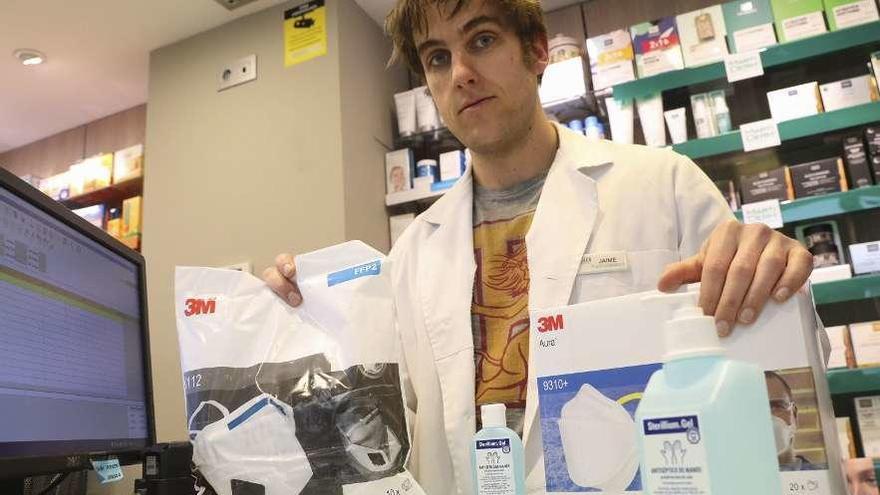 Jaime Ortega-Meder, ayer en su farmacia de Avilés, con dos paquetes de mascarillas reservadas para enviar al extranjero y geles de manos.