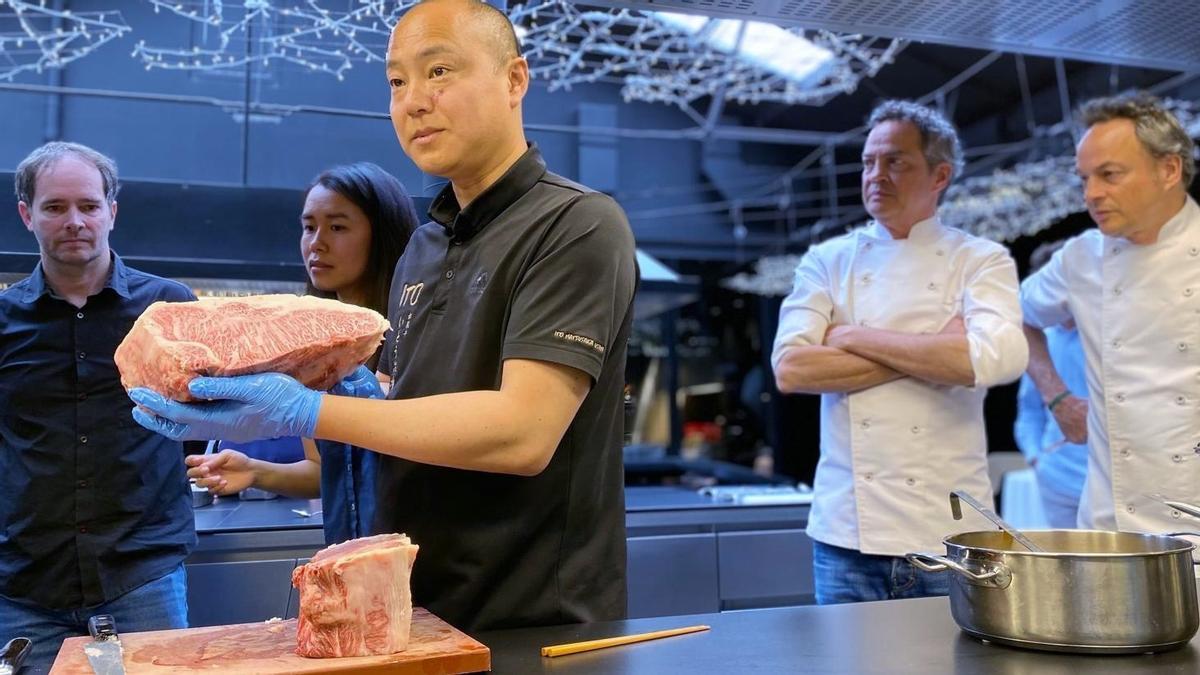 El ganadero Hiroki Ito, de la granja Ito Ranch, muestra un corte de carne Matsusaka Beef, la más cara y prestigiosa de Japón, ante la atenta mirada de Javier y Sergio Torres.