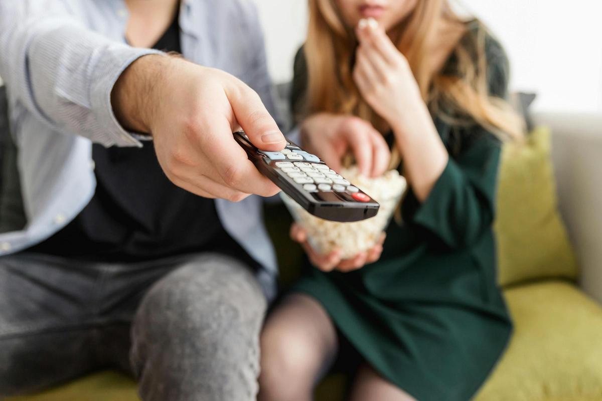 Una pareja come palomitas viendo la tele