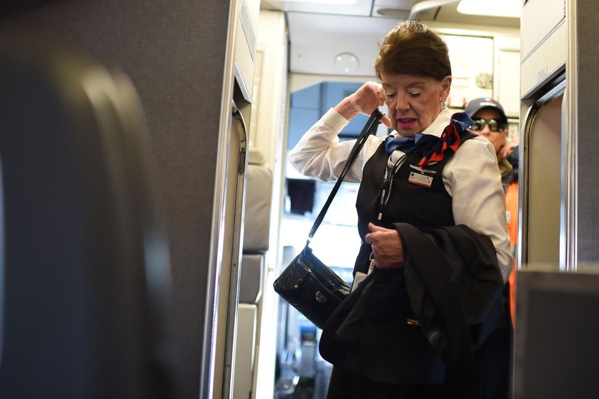 American Airlines longest serving flight attendant, Bette Nash (R), 81 years old, gathers her belongings before disembarking from her daily return flight to Boston at Ronald Reagan Washington Airport in Arlington, Virginia on December 19, 2017.