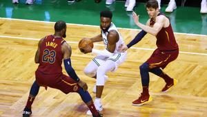 BOSTON, MA - MAY 13: Jaylen Brown #7 of the Boston Celtics is defended by LeBron James #23 and Kyle Korver #26 of the Cleveland Cavaliers during the first quarter in Game One of the Eastern Conference Finals of the 2018 NBA Playoffs at TD Garden on May 13, 2018 in Boston, Massachusetts.   Adam Glanzman/Getty Images/AFP