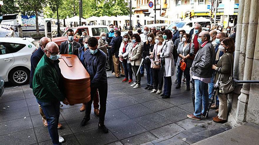 Familiares y amigos portan el féretro de Daniel Jiménez Villa (en el recuadro), ayer, a la entrada de la parroquia de San Lorenzo. | Juan Plaza