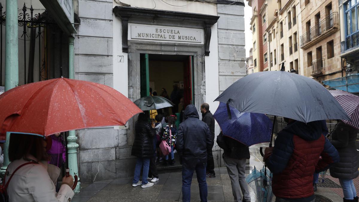 Padres esperando por sus hijos a las puertas de la Escuela de Música.