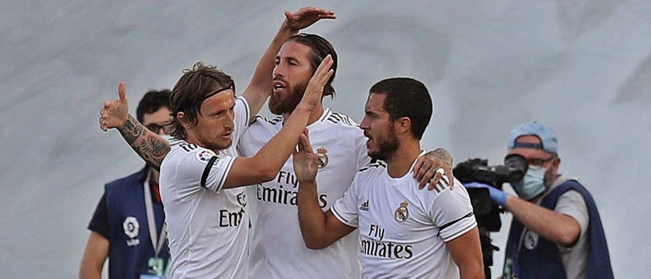 Hazard (d) y Modric (i) felicitan a Sergio Ramos por su gol.