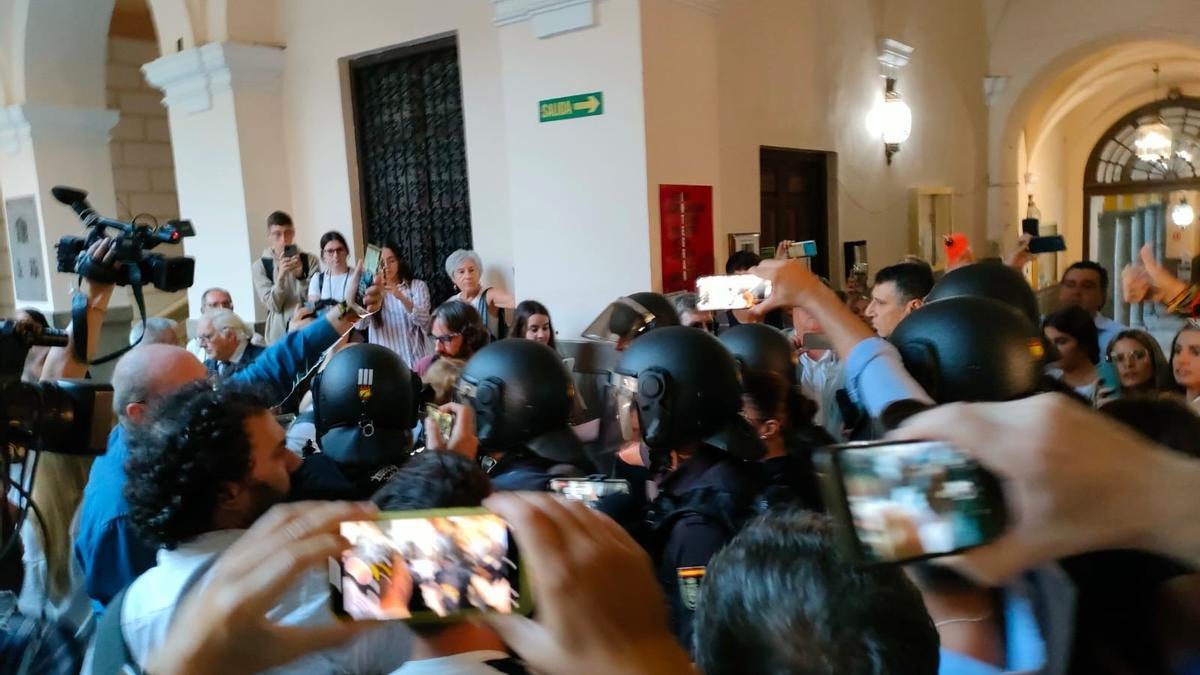 Detractores y simpatizantes de Macarena Olona, a su llegada a la Facultad de Derecho de Granada, rodeada de policías y periodistas