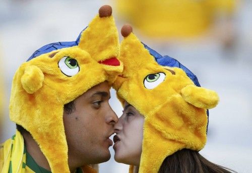 A couple embrace as they wait for the start of the 2014 World Cup round of 16 game between Brazil and Chile at the Mineirao stadium in Belo Horizonte