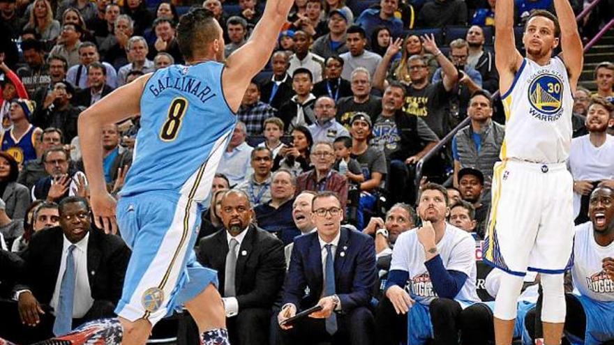 Stephen Curry llança davant l&#039;atenta mirada de l&#039;italià Gallinari