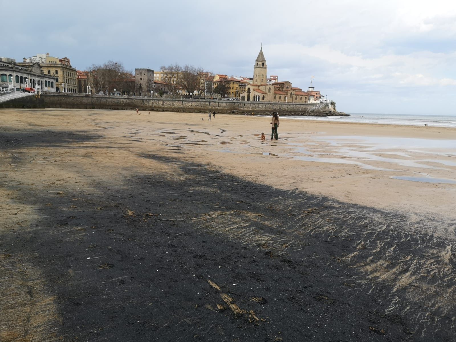 En imágenes: una nueva marea de carbón tiñe de negro la playa de San Lorenzo